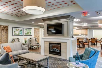 Bright common area with seating and decorative ceiling