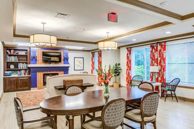 Bright common area with seating and a fireplace
