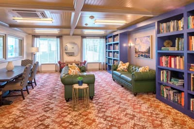 Cozy common area with seating and bookshelves