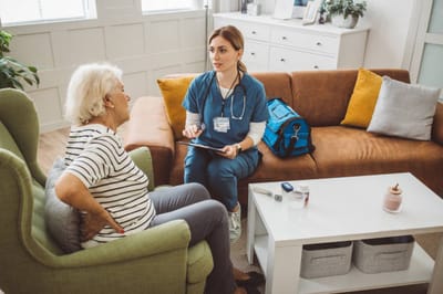 Lorien Bulle Rock, Nursing Home in Havre De Grace, MD — Healthcare professional consulting with a senior resident in a cozy setting