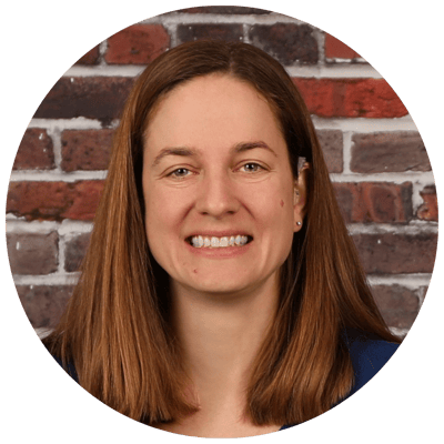 Lorien Bulle Rock, Nursing Home in Havre De Grace, MD — Smiling woman against a brick wall background