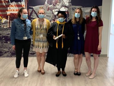 Staff celebrating a graduation event indoors