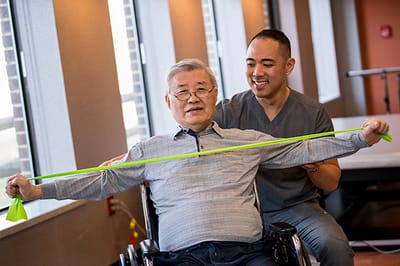 Resident engaging in physical therapy session with staff