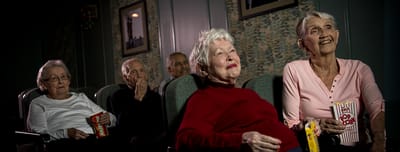 Residents enjoying a movie night with popcorn