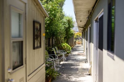Narrow pathway between two buildings with seating