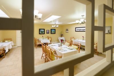 Dining room with tables set for residents
