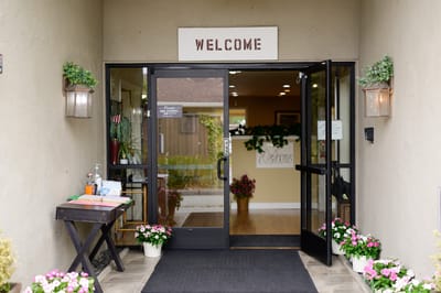 Entrance to Maple House with a welcoming sign