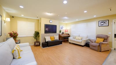 Bright common area with seating and piano