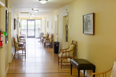 Hallway with seating and artwork in a senior living facility