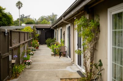 Pathway lined with flowers leading to individual living units