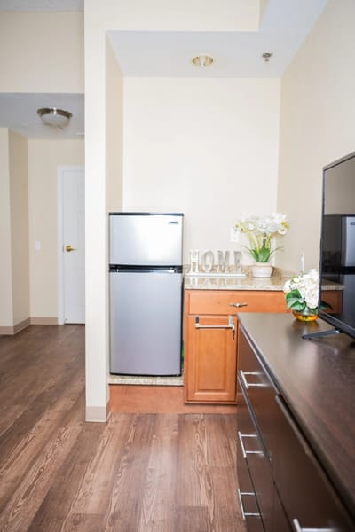 Interior view of a resident's room with a mini fridge