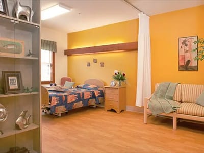 Cozy resident room with a bed and seating area