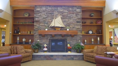 Cozy lobby area with stone fireplace and seating