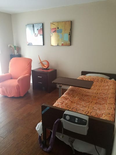 Cozy resident room with a bed and chair