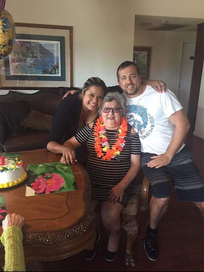 Residents celebrating a birthday with family in a cozy living room