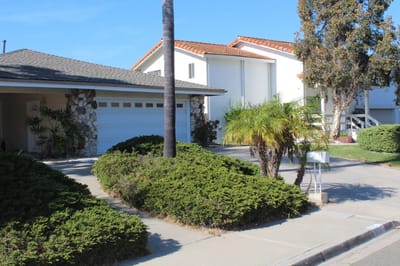 Exterior view of the facility with landscaping and buildings