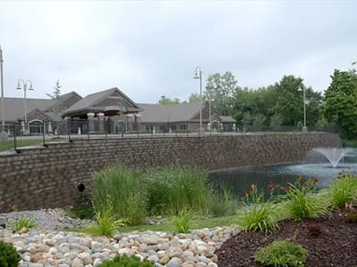 Exterior view of the facility with landscaped pond