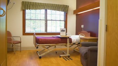 Private resident room with beds and seating area