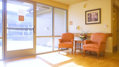 Bright common area with chairs and flower arrangement
