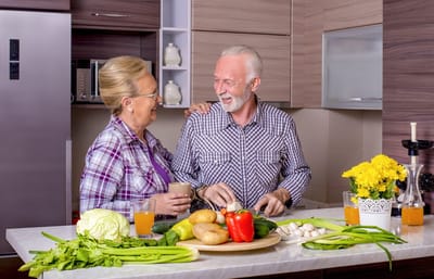 Couple preparing food in a bright kitchen setting
