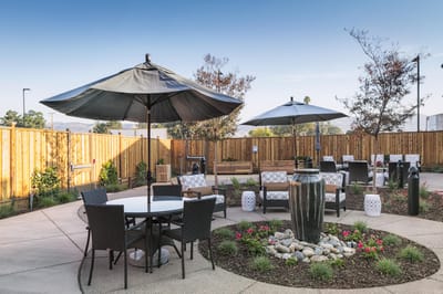 Outdoor seating area with umbrellas and landscaping