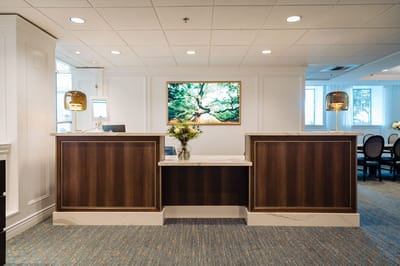 Reception area with wooden desks and artwork