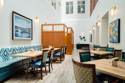 Bright dining area with tables and chairs