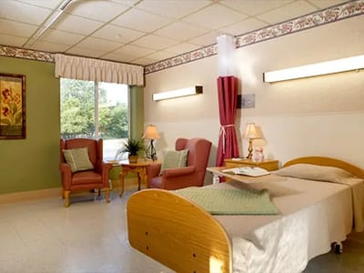 Cozy resident room with chairs and a bed
