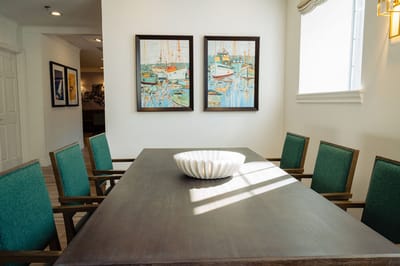 Bright common area with artwork and dining table