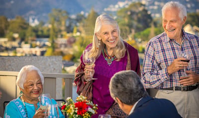Residents enjoying a gathering on a balcony