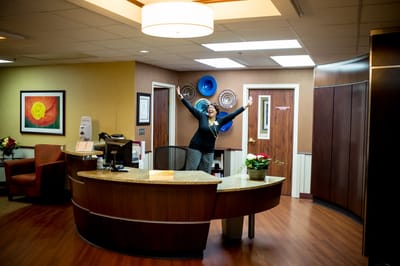 Reception area with a staff member welcoming visitors