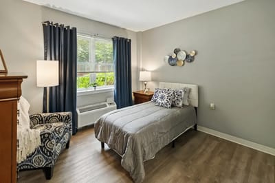 Cozy private bedroom with a bed and seating area