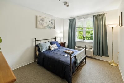 Cozy resident room with a bed and window.