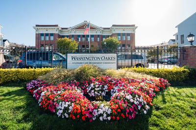 Exterior view of Washington Oakes with flower bed