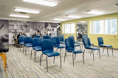 Interior view of a fitness activity room with chairs