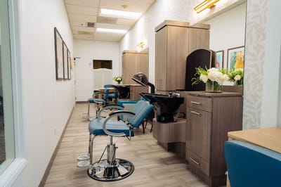 Interior view of a salon space with chairs and sinks