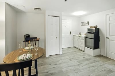 Bright kitchen area with dining table and appliances