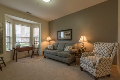 Cozy interior lounge area with a sofa and chairs