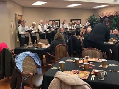 Residents enjoying a musical performance in a common area