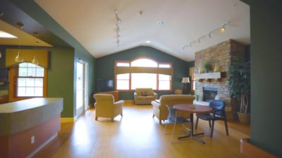 Bright interior of a common area with furniture and a fireplace