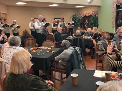 Residents enjoying a musical performance in a common area