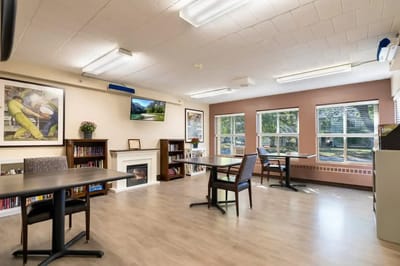 Interior activity room with seating and a TV