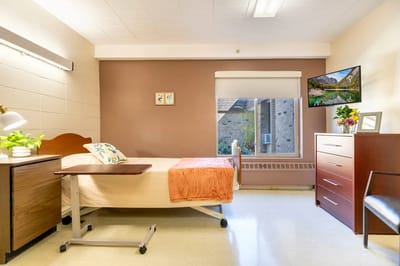 Comfortable resident room with a bed and furnishings