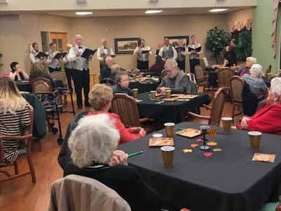 Residents enjoying a musical performance in the common area
