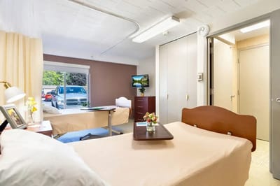Private resident room with a bed and desk