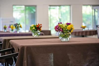 Dining room setup with flower arrangements on tables