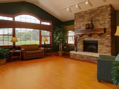 Comfortable common area with stone fireplace and large windows
