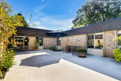 Sunny outdoor patio area with seating and umbrellas