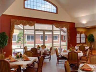 Interior view of a dining room with tables set for meals