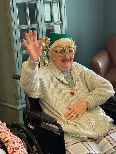 Resident waving happily in a festive setting